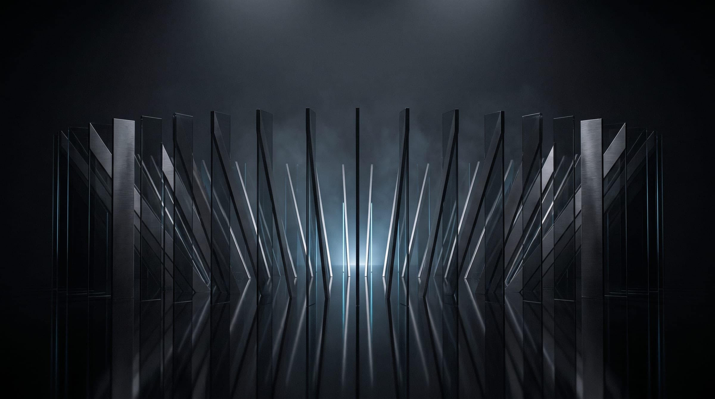 A ring of tall glass and metal fins lit from behind in a vast dark studio